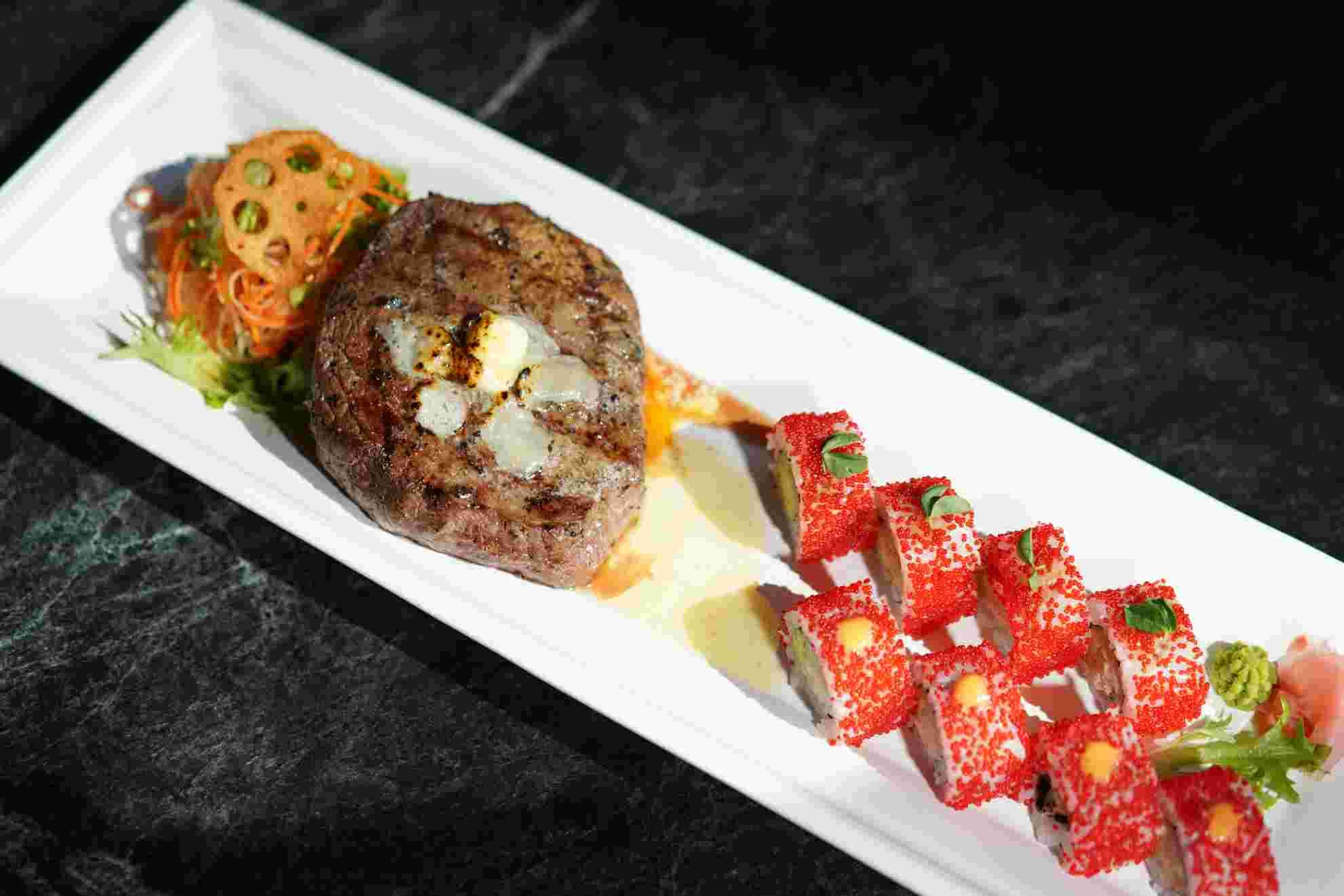 Wagyu steak and tobiko-crusted rolls plated together
